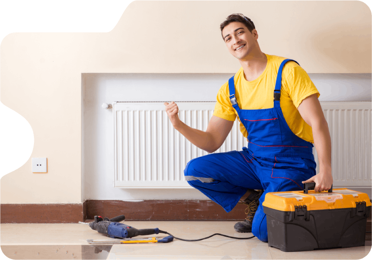 handyman smiling after fixing a heater